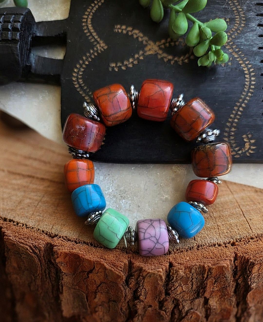 Beaded bracelet with brown, blue, and purple beads on a wooden surface