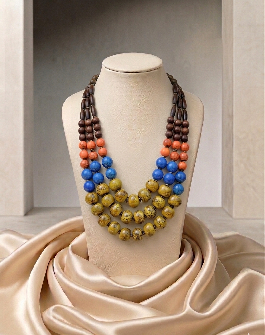 Colorful beaded necklace on a mannequin bust with a neutral background