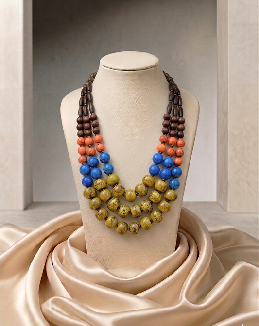 Colorful beaded necklace on a mannequin bust with a neutral background