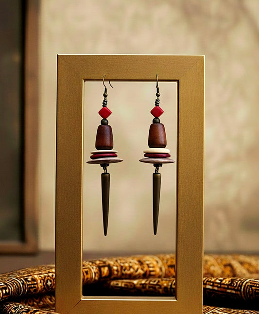Pair of earrings with red and brown beads in a gold frame.