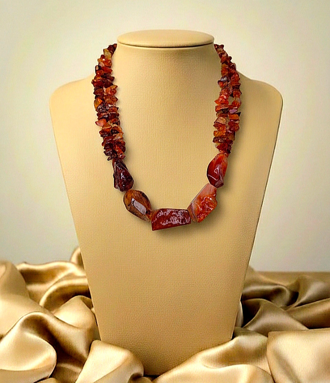 Necklace with large brown beads on a beige mannequin against a beige background