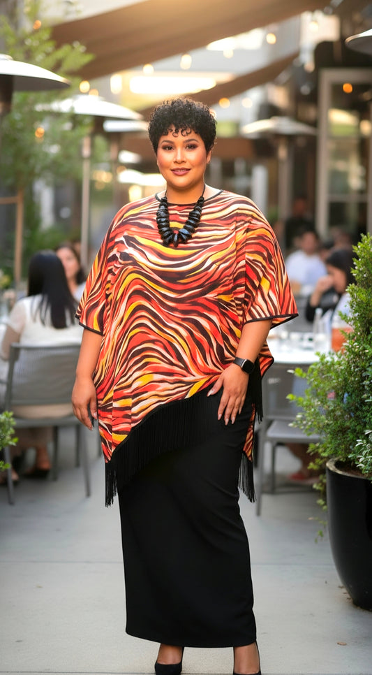 Woman wearing a colorful patterned top and black skirt outdoors.
