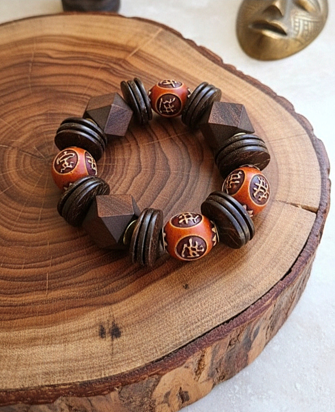 Wooden bracelet with geometric beads on a wooden surface