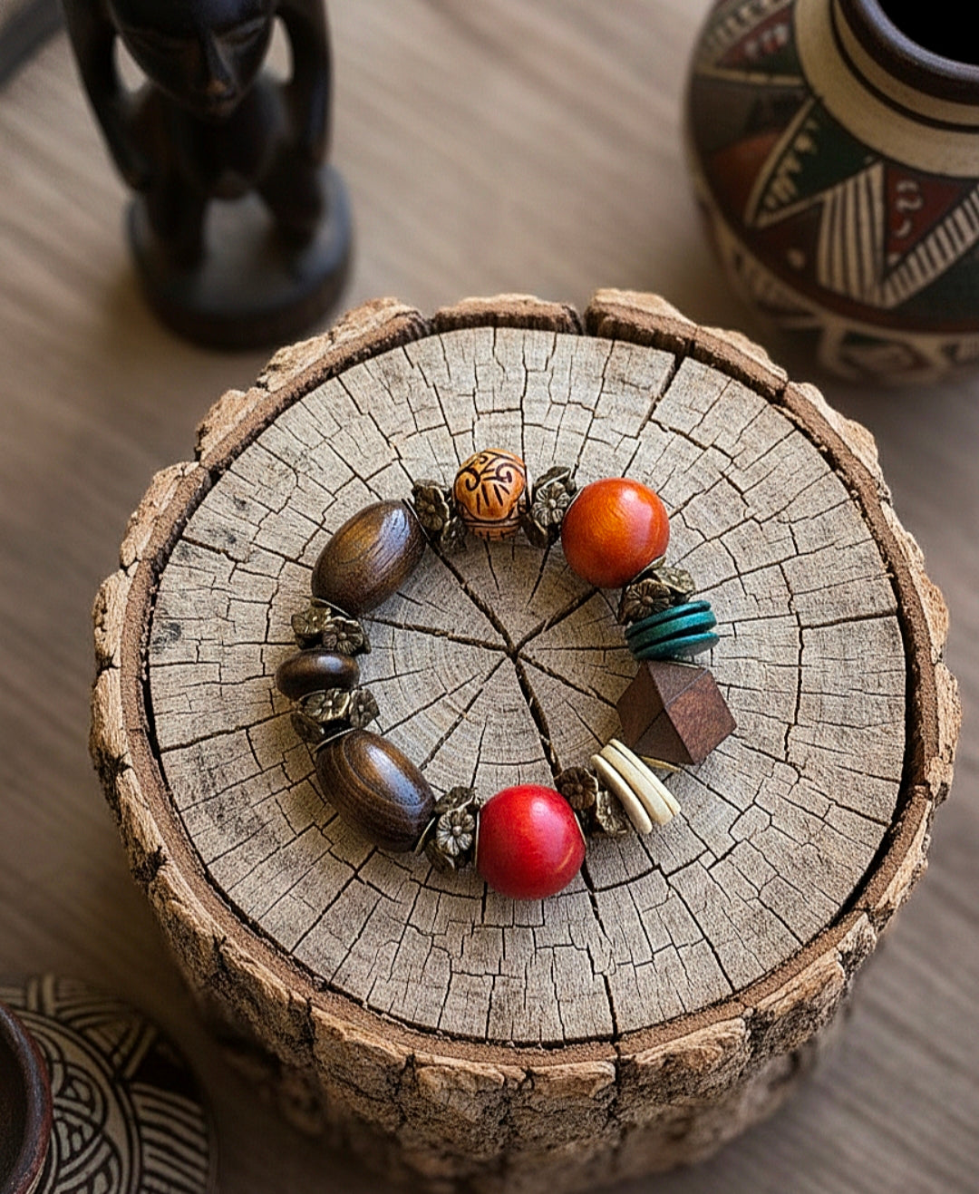 Beaded bracelet on a wooden surface with decorative elements in the background