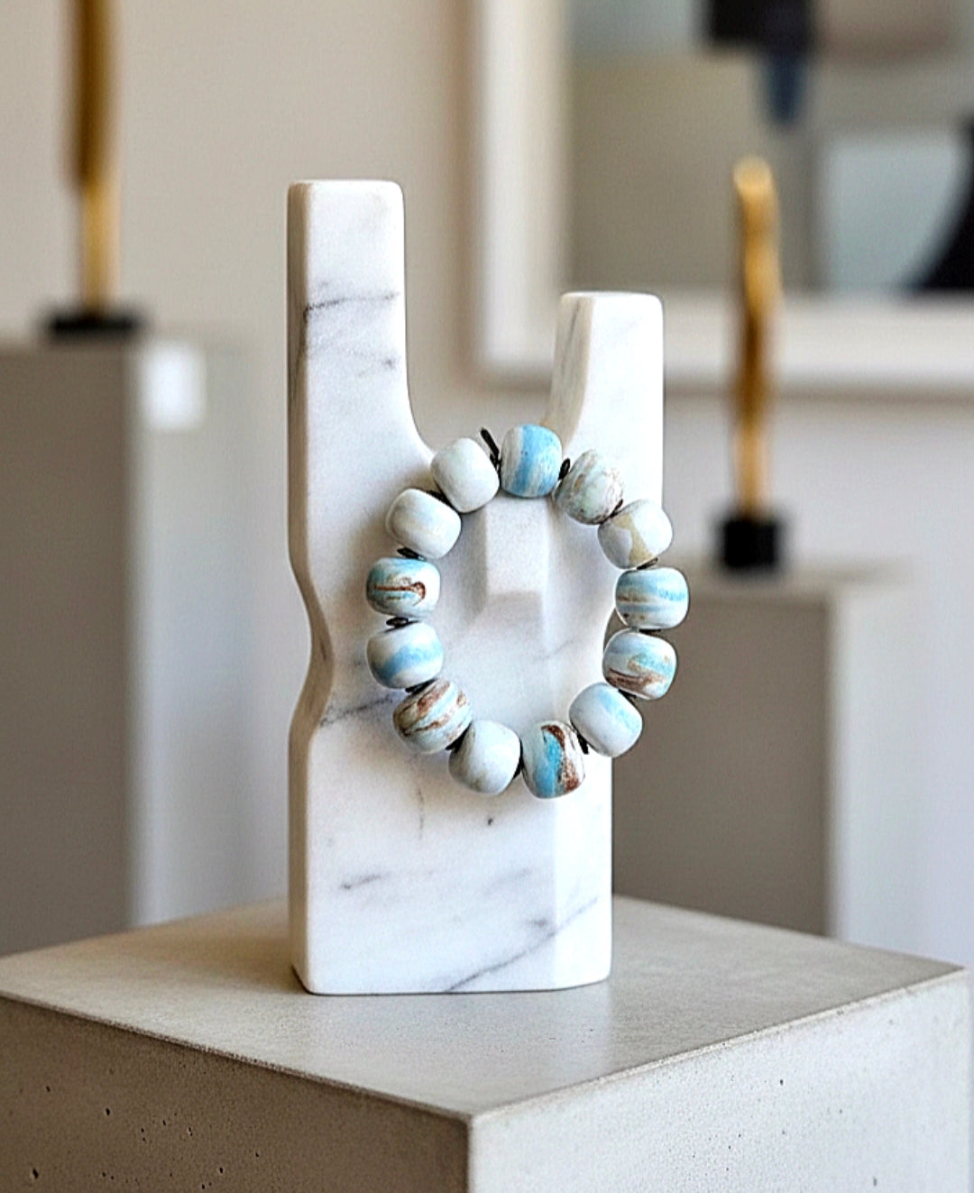 Decorative wreath on a marble stand with a blurred indoor background