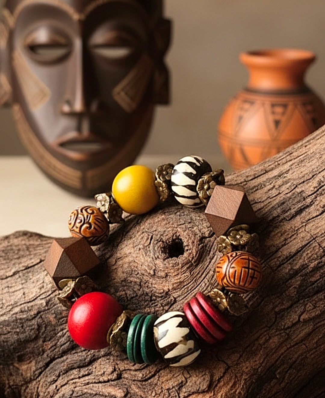 Colorful beaded bracelet on a wooden surface with an African mask and vase in the background