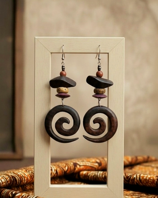 Pair of spiral wooden earrings on a neutral background