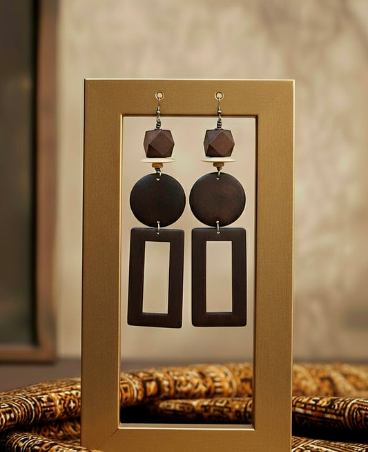 Pair of earrings displayed on a gold card with a blurred background