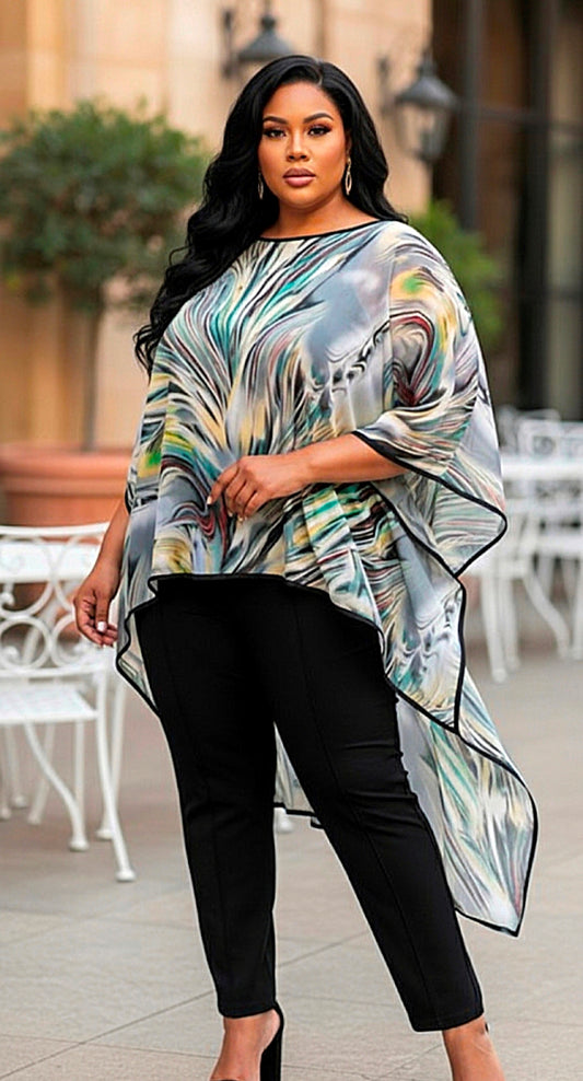 Woman wearing a colorful, patterned top with black pants in an outdoor setting.