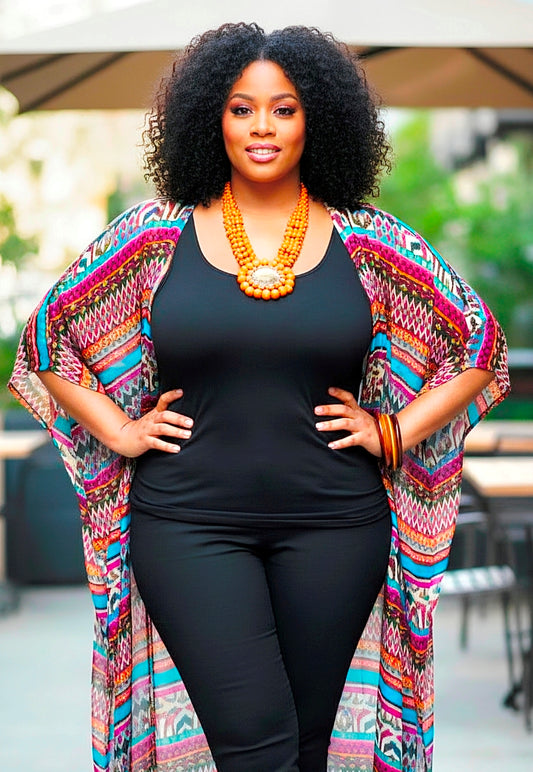 Woman wearing a colorful kimono over a black outfit with a blurred outdoor background