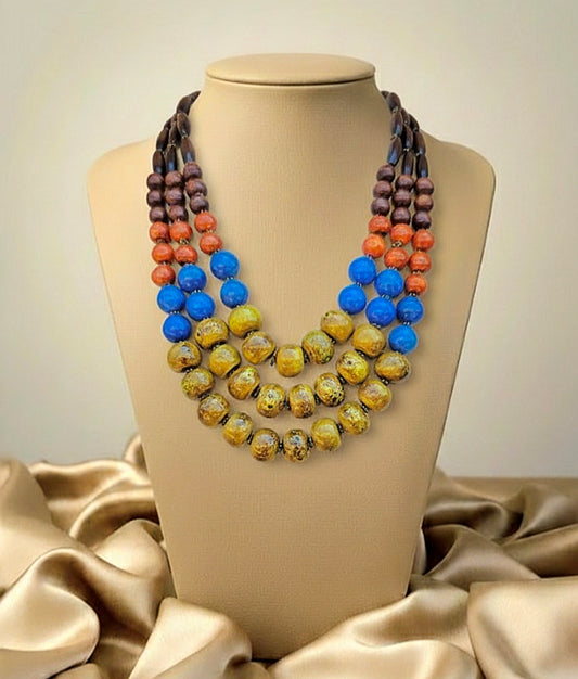 Colorful beaded necklace on a mannequin bust with a beige background