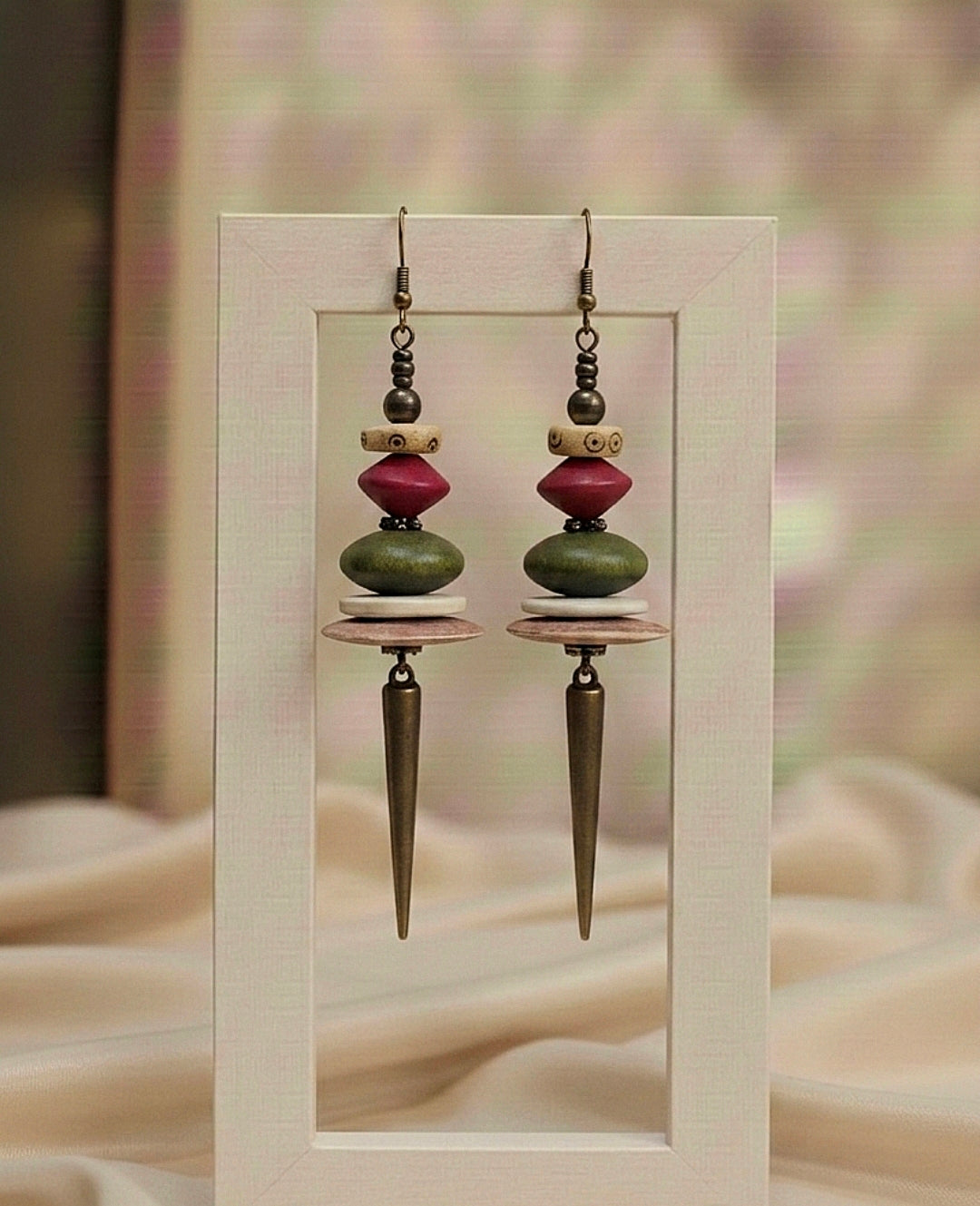 Pair of earrings with geometric design on a neutral background