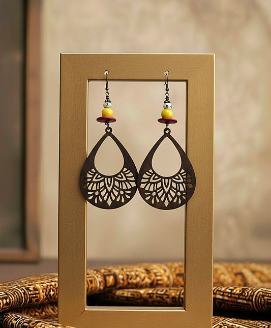 Pair of earrings displayed in a gold frame against a neutral background