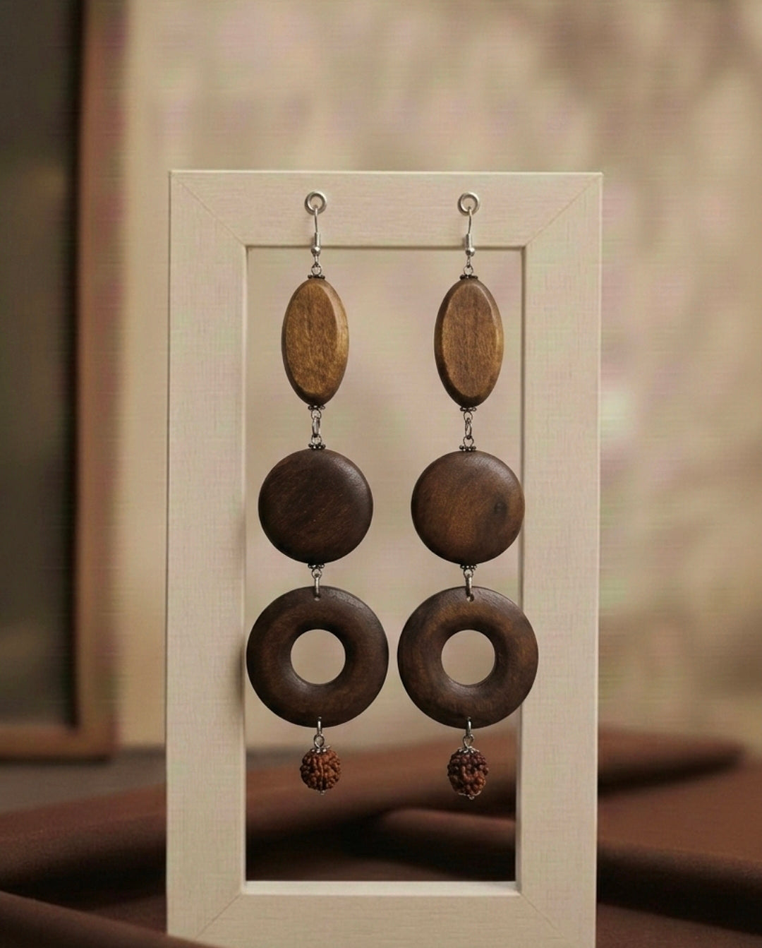 Wooden earrings with circular designs in a neutral frame.
