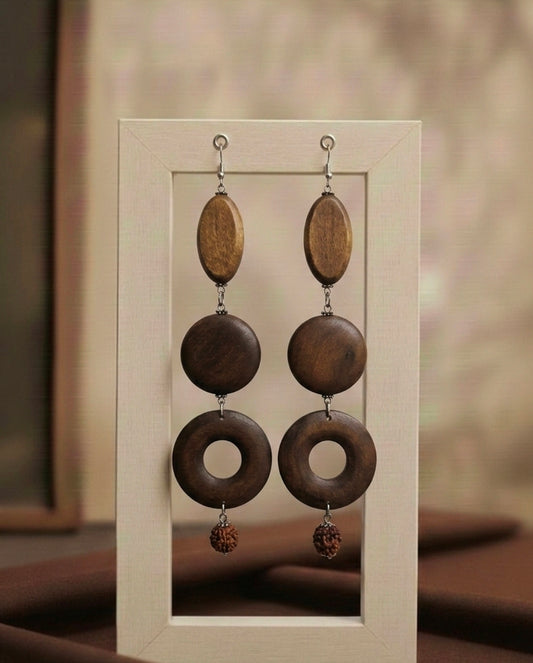 Wooden earrings with circular designs in a neutral frame.