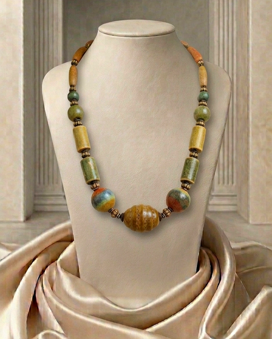 Necklace with multicolored beads on a mannequin bust against a neutral background