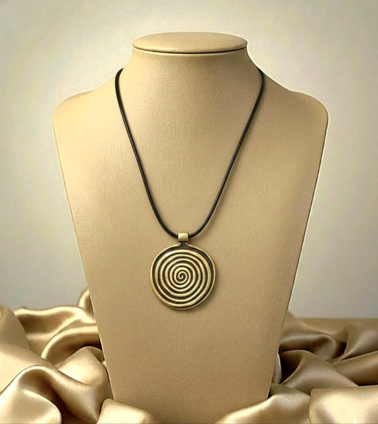 Necklace with a spiral pendant on a mannequin bust against a neutral background