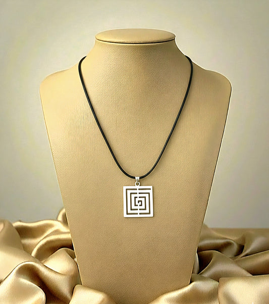 Necklace with a square pendant on a beige mannequin bust against a beige background
